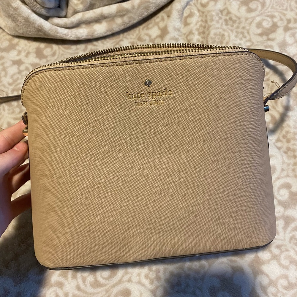 Kate Spade purse, beige. Has some flaws but overall still a good quality purse.